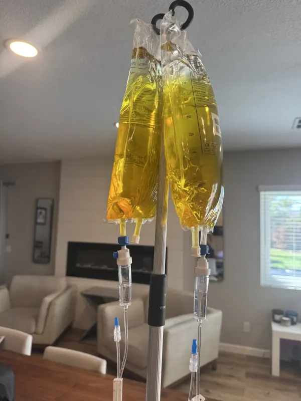IV bags hanging from a stand in a client's living room